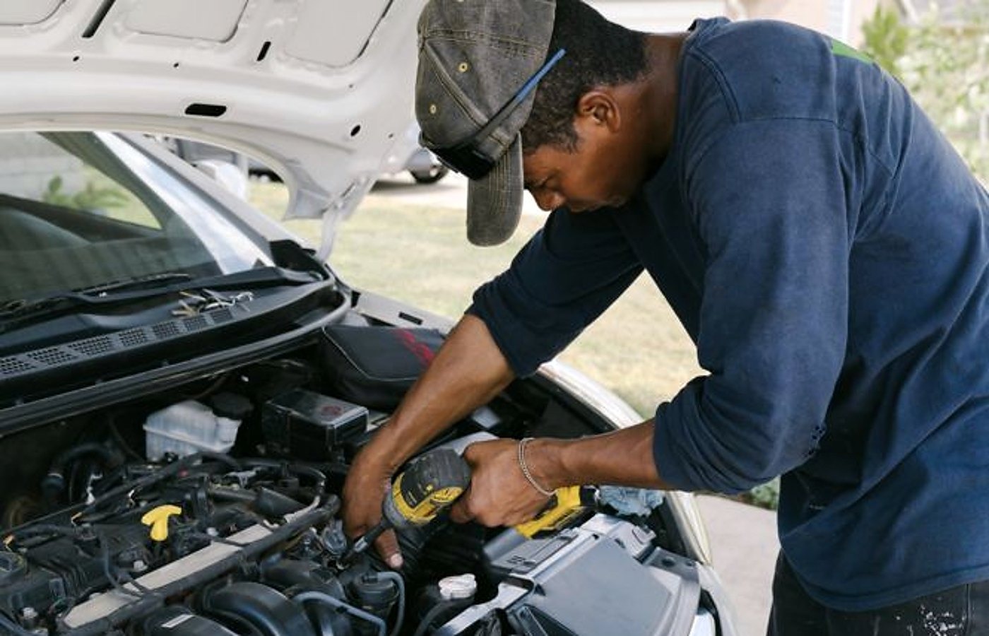 El Paso mobile mechanic working under a hood at a customer home